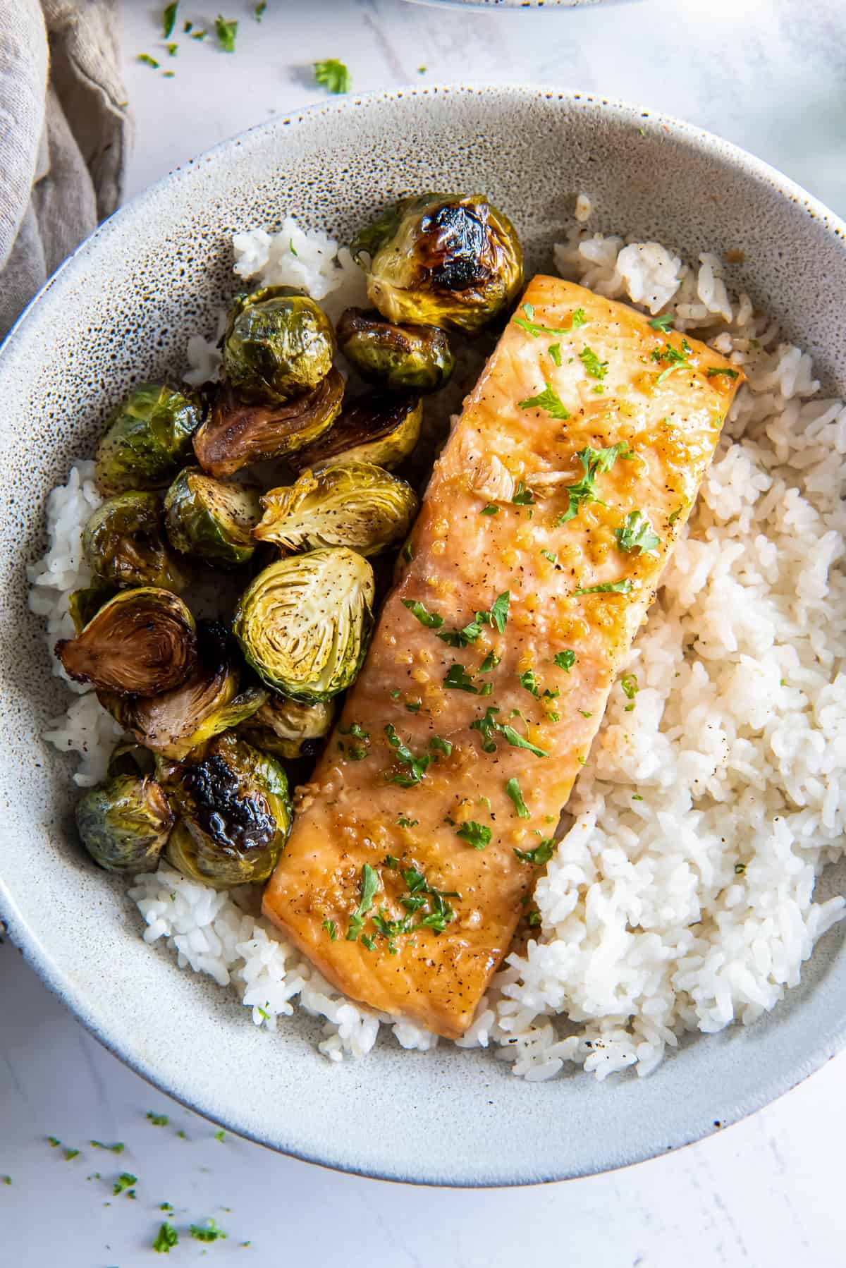 Roasted Salmon in a bowl with rice and brussels sprouts.