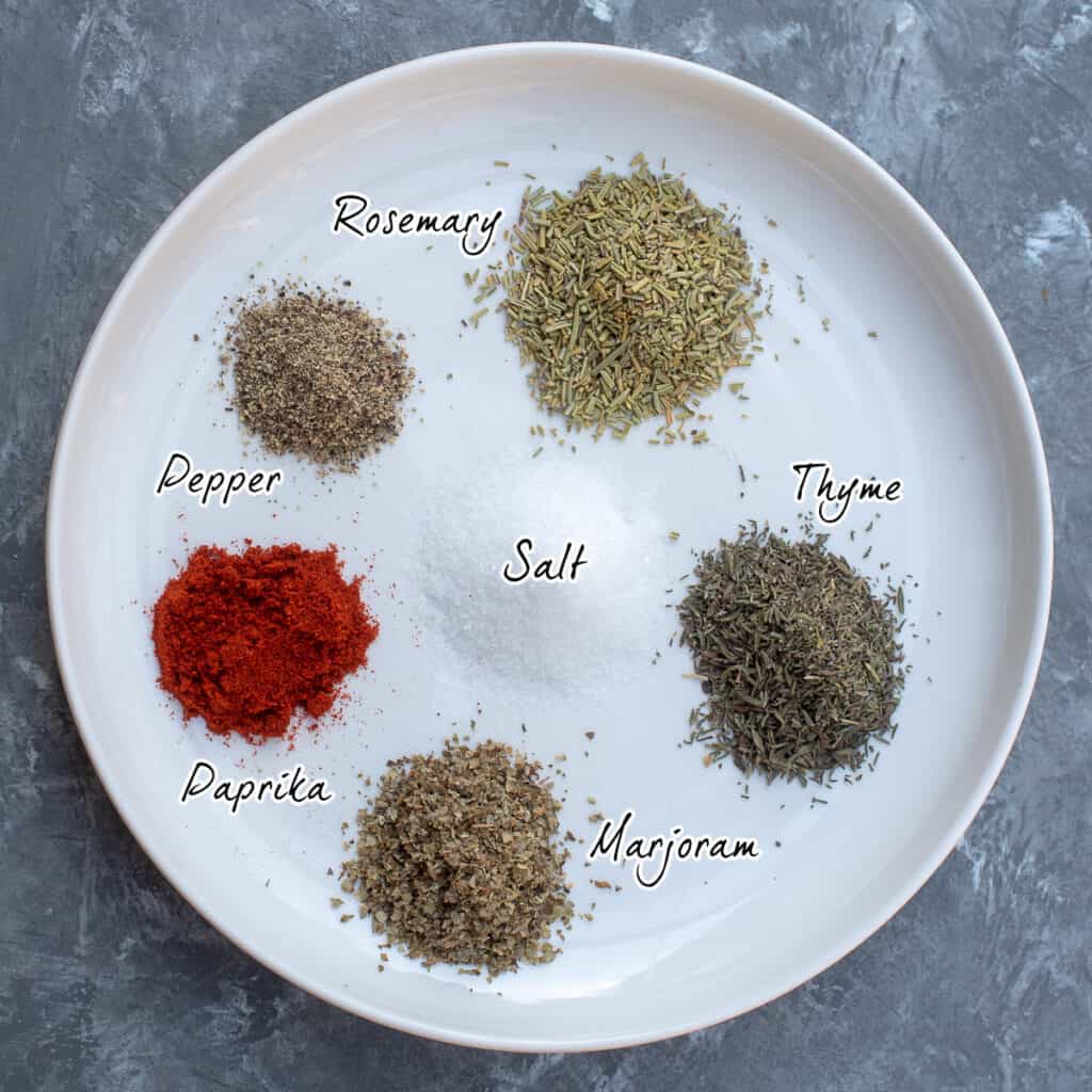 Assorted dried seasonings on a white plate with text.