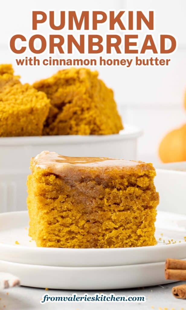 A slice of pumpkin cornbread with melted cinnamon honey butter on a white plate with text.