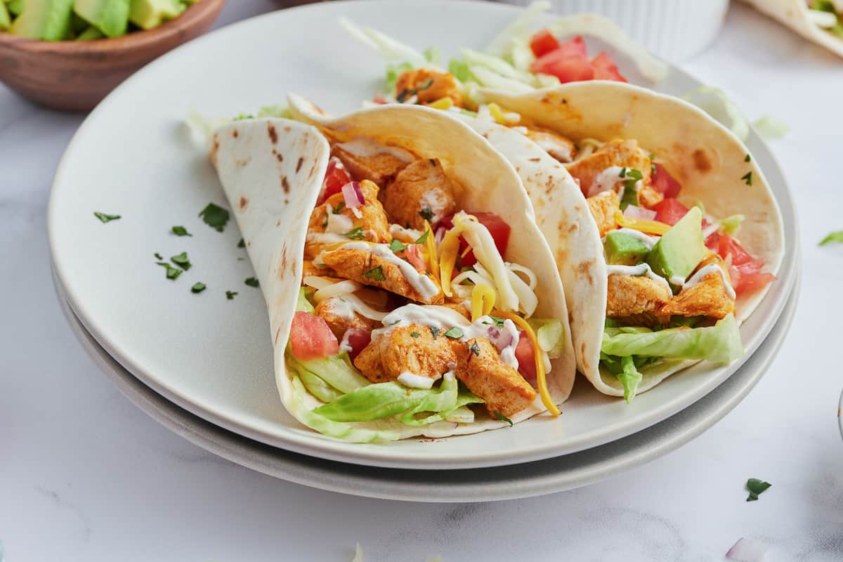 Ranch chicken tacos on a white plate.