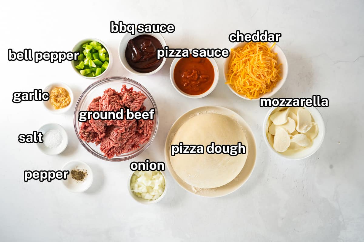Pizza dough, ground beef and other pizza ingredients on a white surface with text.