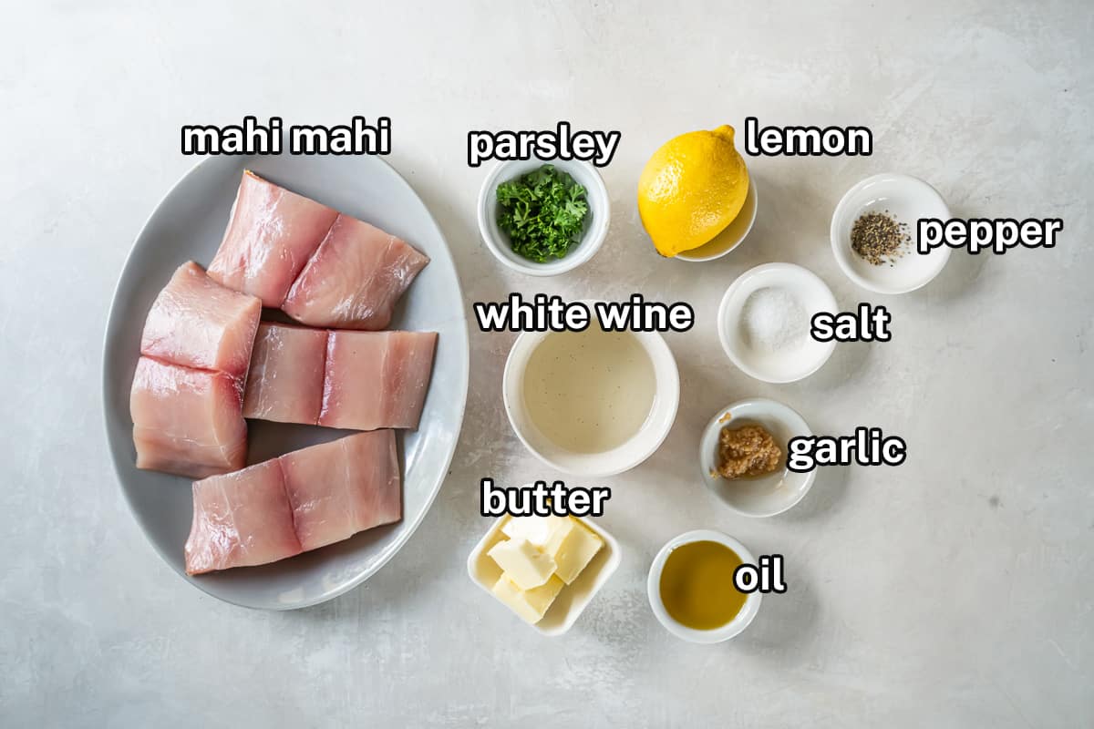 Mahi mahi fillets and other ingredients on a grey surface with text.