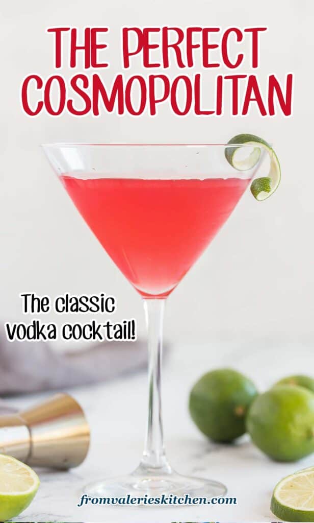 A cosmopolitan cocktail in a martini glass with a slice of lime on the rim on a kitchen counter with text overlay.