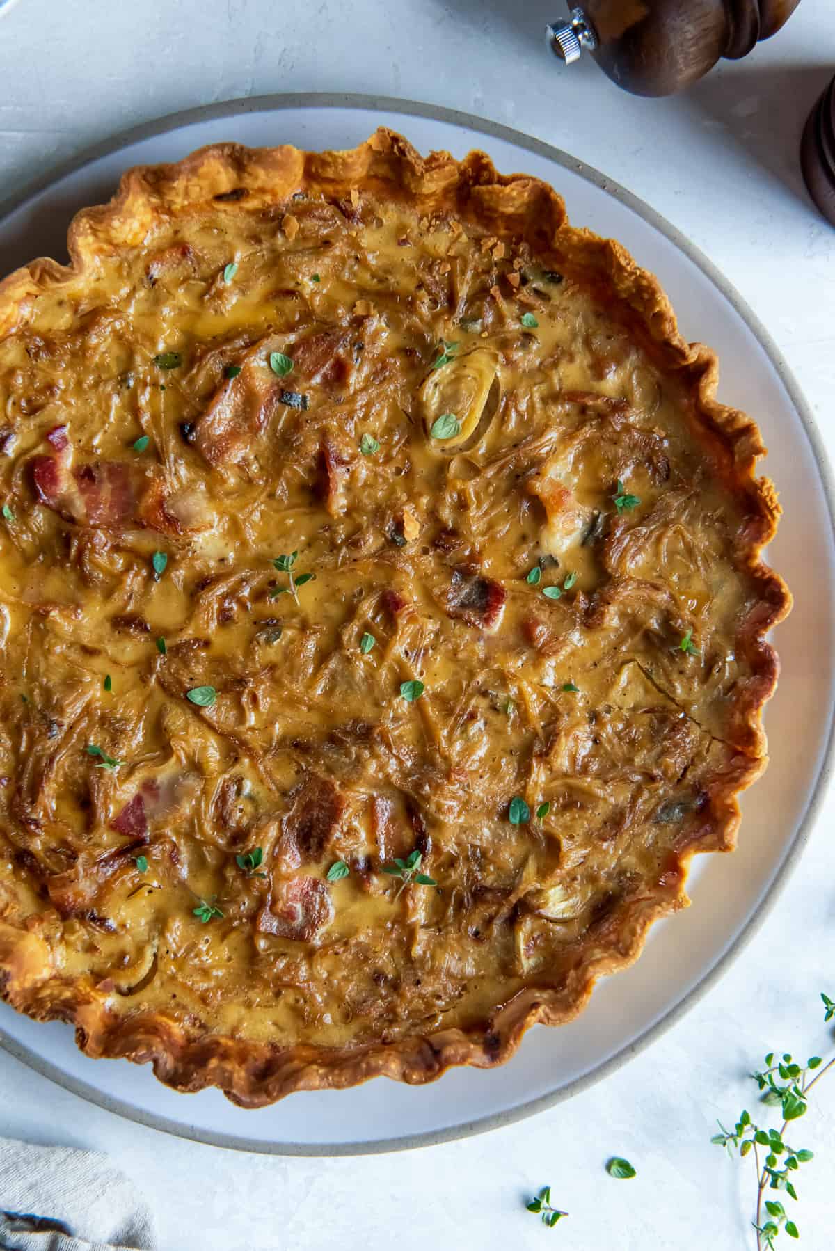 A top down close up of a tart with caramelized onions.