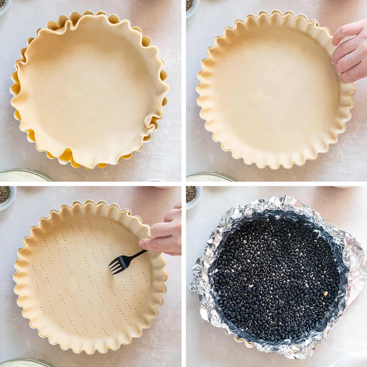 Four images of pie crust being placed in a tart pan, pricked with a fork, and lined with foil and dried beans.
