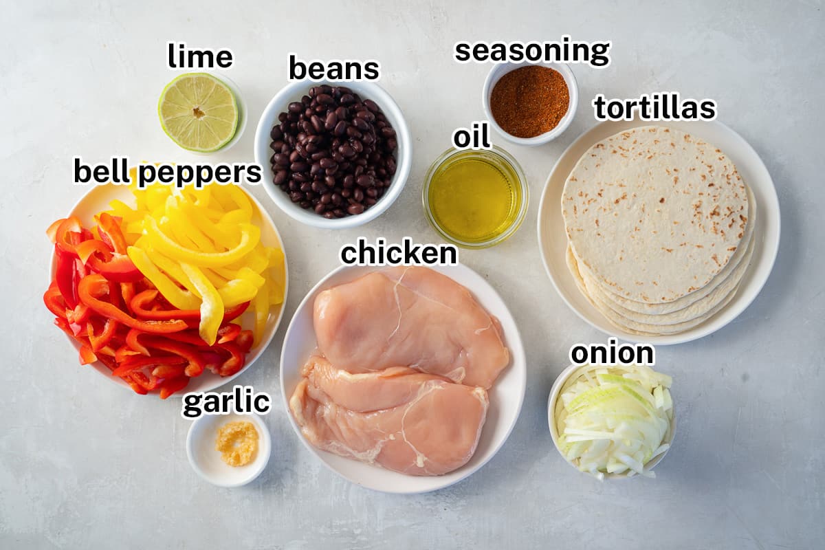 Chicken, bell peppers, onions, and other ingredients for fajitas with text.