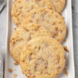 A row of Butter Toffee Cookies on a narrow white platter.