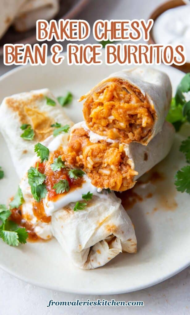 A burrito is sliced in half to reveal beans, rice, and cheese and stacked on top of another burrito with sour cream and salsa with text.