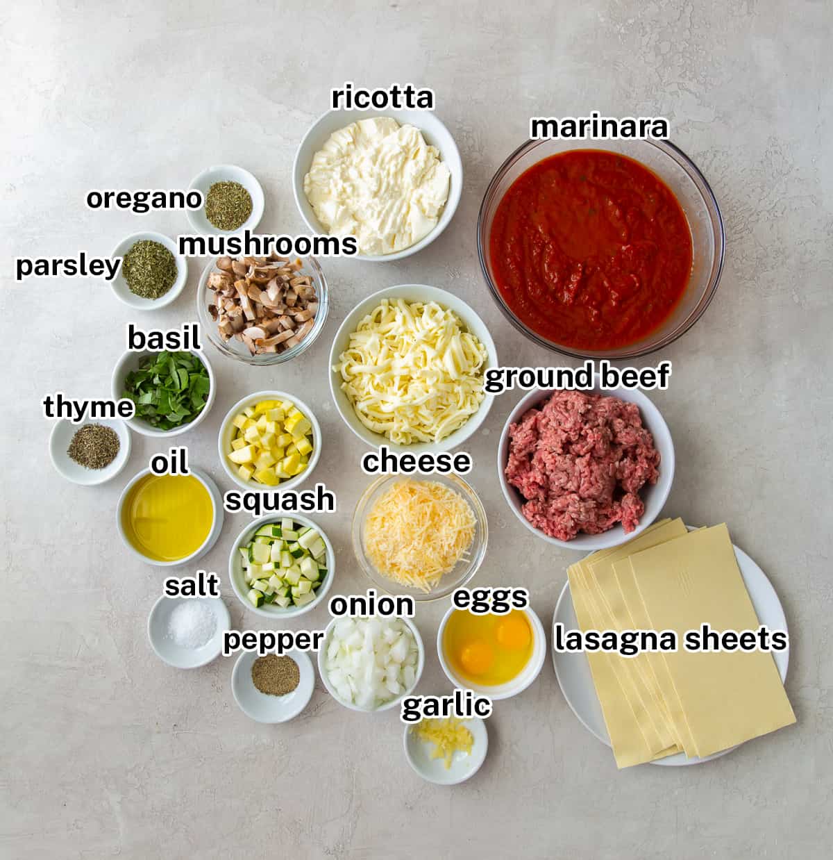 Marinara, cheese, and other ingredients in small bowls with text.