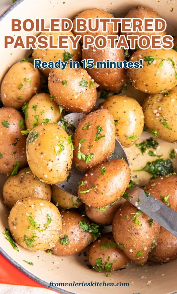 A top down shot of parsley potatoes in a Dutch oven with a spoon with text.