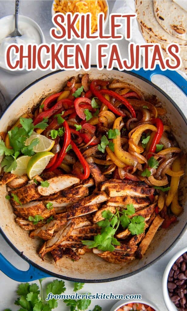 A top down shot of chicken fajitas in a skillet with lime wedges and cilantro with text.