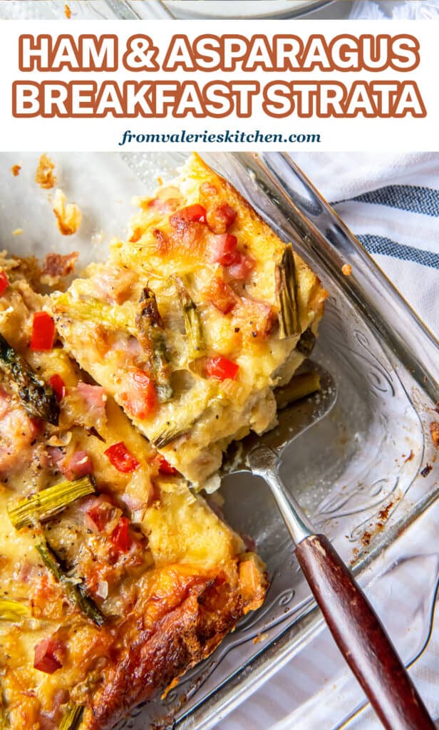 A top down shot of a spatula resting under a slice of breakfast strata in a baking dish with text.
