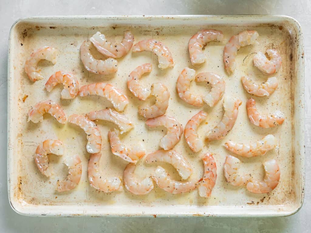 Shrimp spread out over a baking sheet.