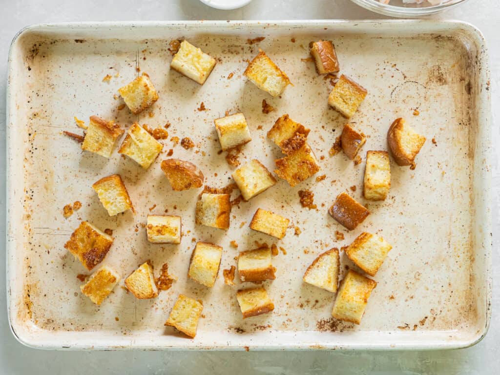 Toasted croutons on a baking sheet.
