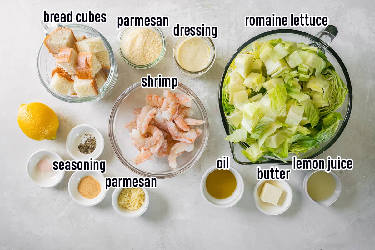 Shrimp, bread cubes, Caesar salad dressing, and other ingredients in bowls with text.