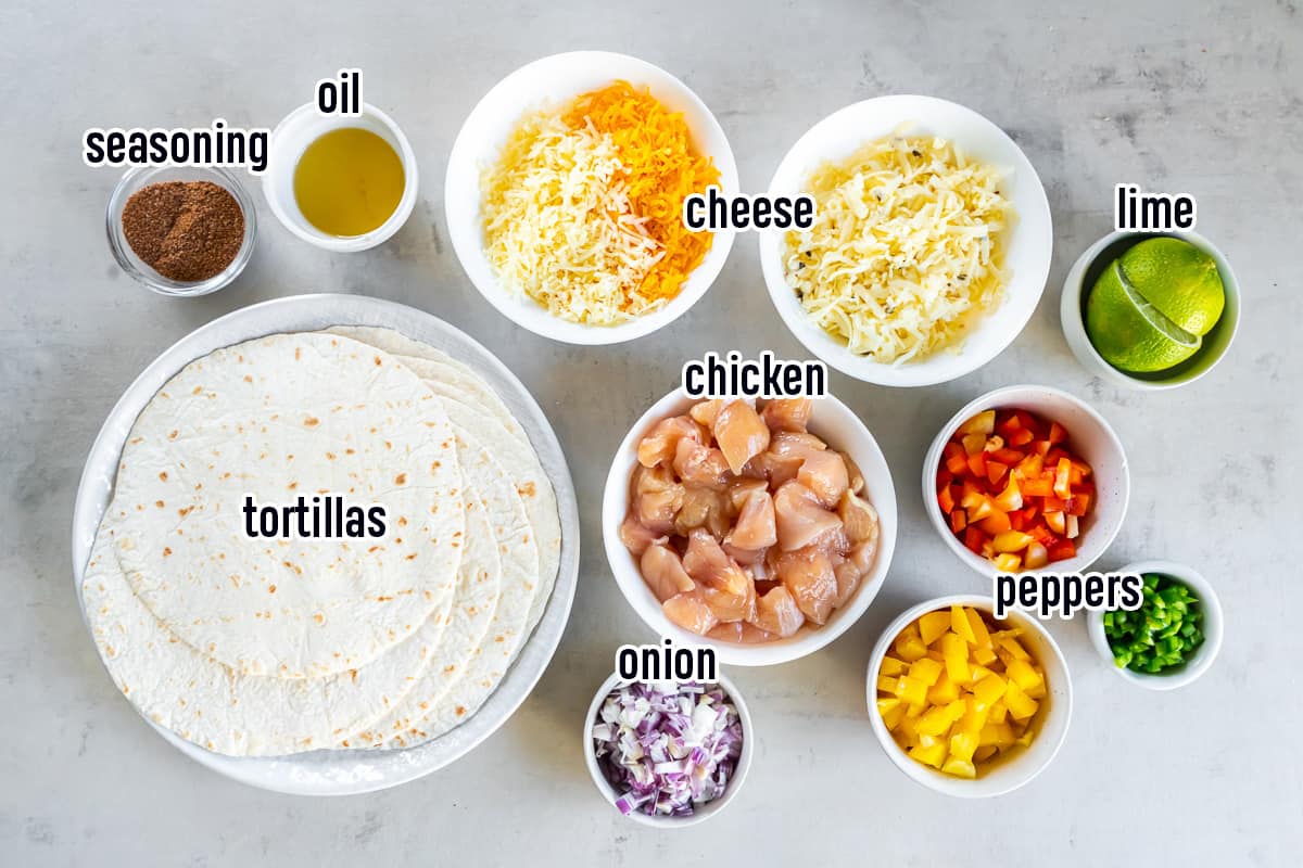 Chicken, peppers, onions, cheese and other ingredients in bowls with text.