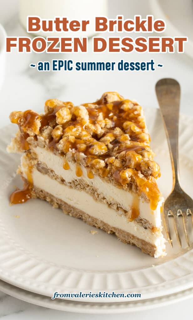 A slice of frozen dessert with ice cream topping drizzled over the top on a white plate with a fork with text.