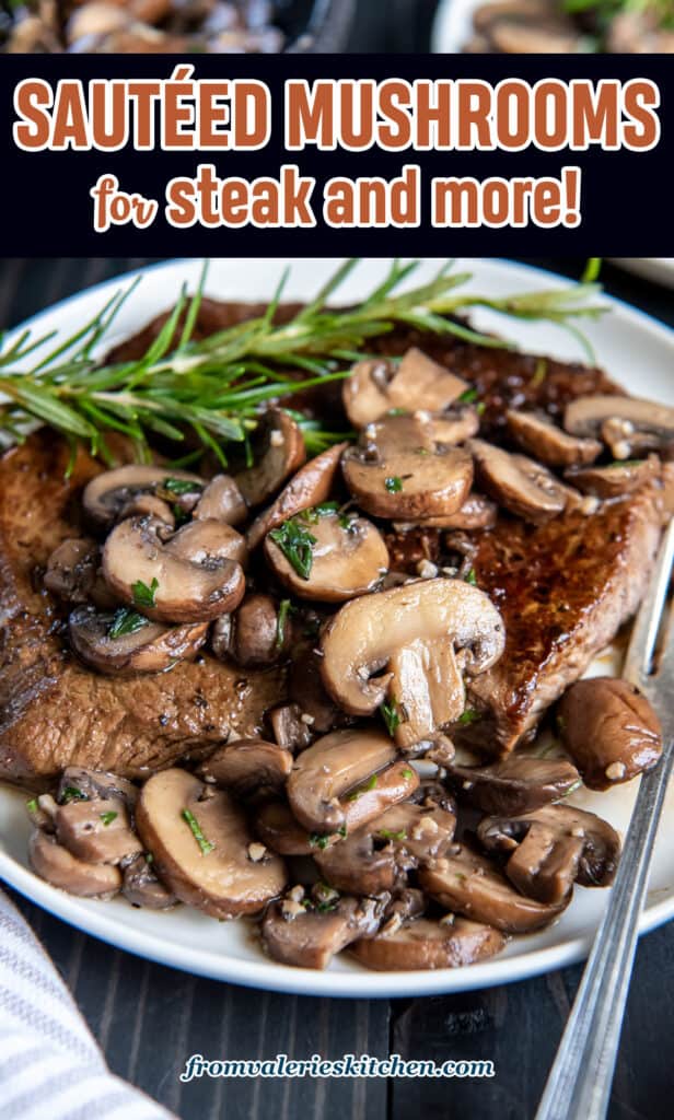 Cooked steak smothered with sauteed mushrooms on a white plate with a fork.