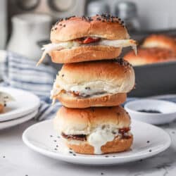 A stack of three Turkey Bacon Ranch Sliders on a white plate.