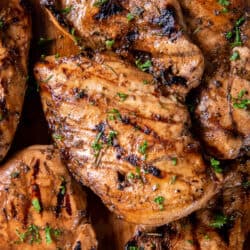 A top down close up shot of grilled chicken breasts.