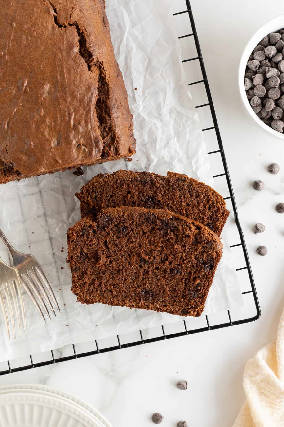 A top down shot of two slices of chocolate peanut butter banana bread on a wire rack.