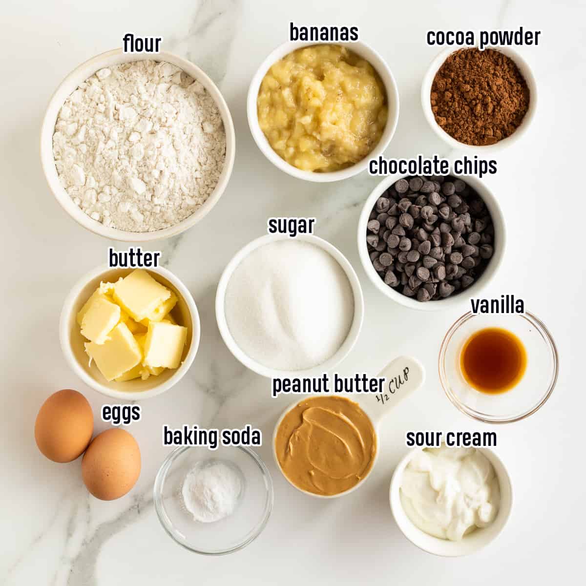 Flour, mashed bananas, chocolate chips and other ingredients in bowls with text.