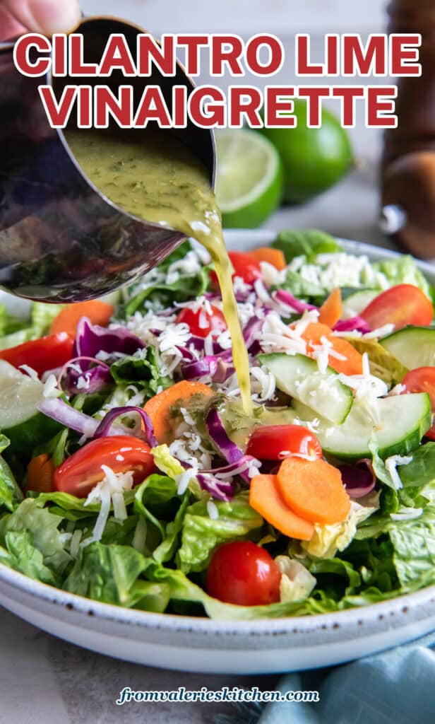 A hand pouring cilantro lime vinaigrette on to a colorful salad with text.