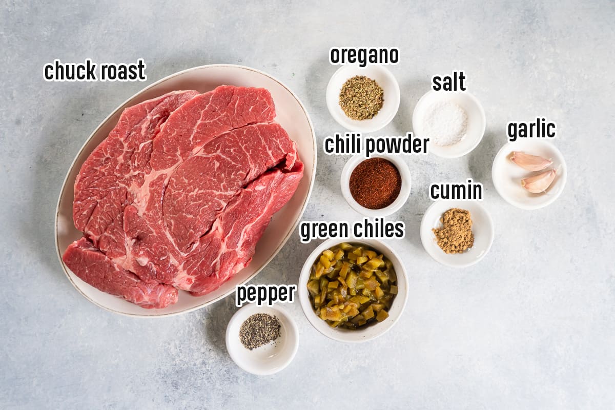 Chuck roast, garlic cloves, and dried spices in bowls with text.