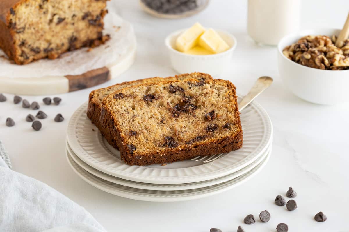 Two slices of chocolate chip banana bread on a white plate.