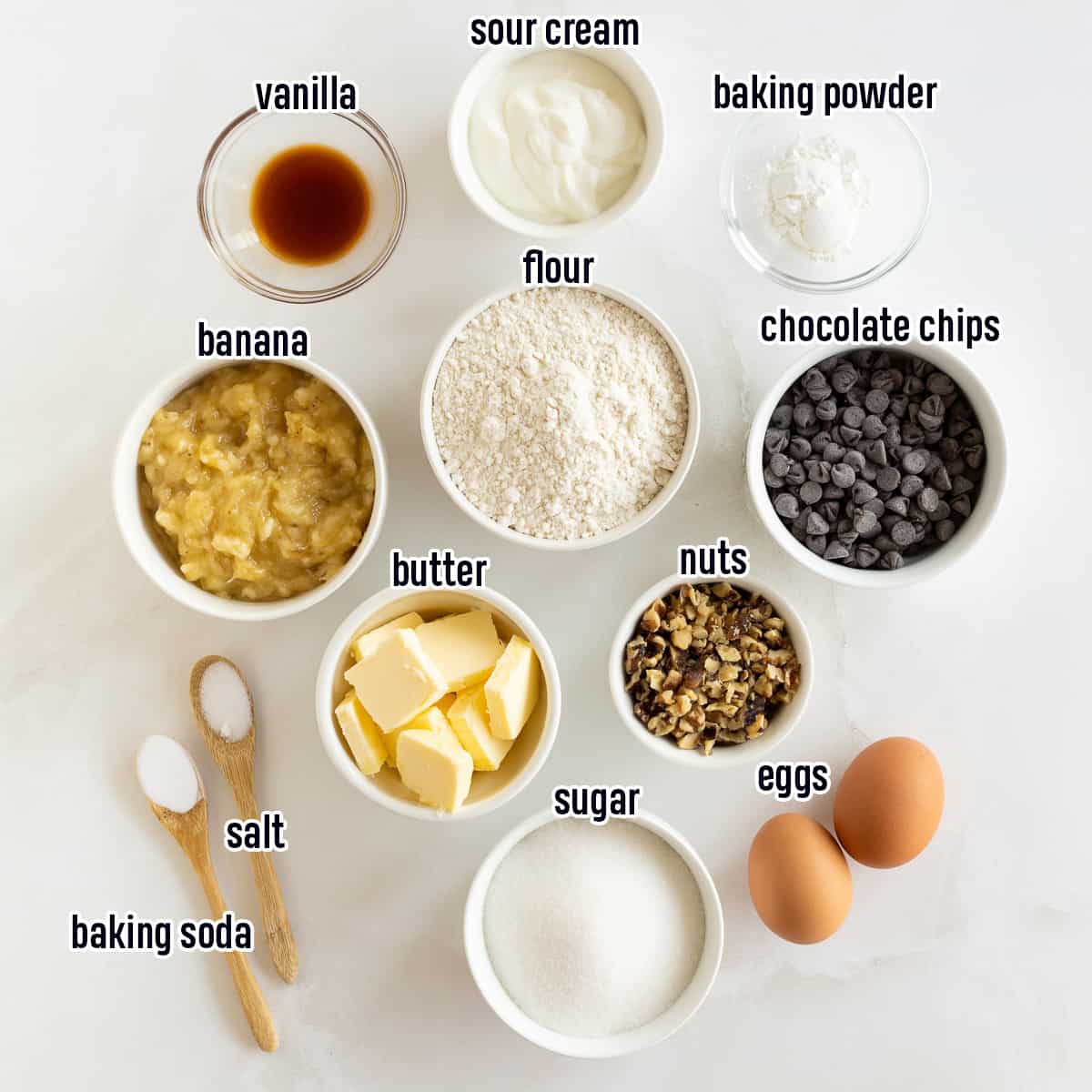 Flour, sour cream, mashed banana, chocolate chips, and other ingredients in bowls with text.