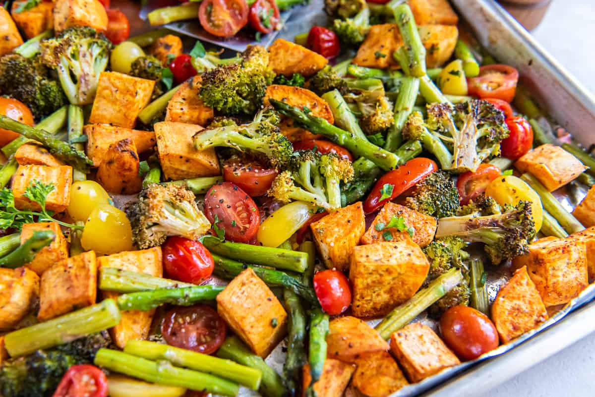 A close up of roasted vegetables on a sheet pan.