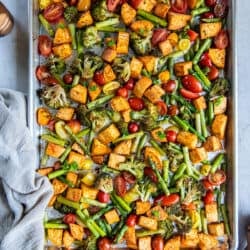 A top down shot of roasted vegetables on a sheet pan.