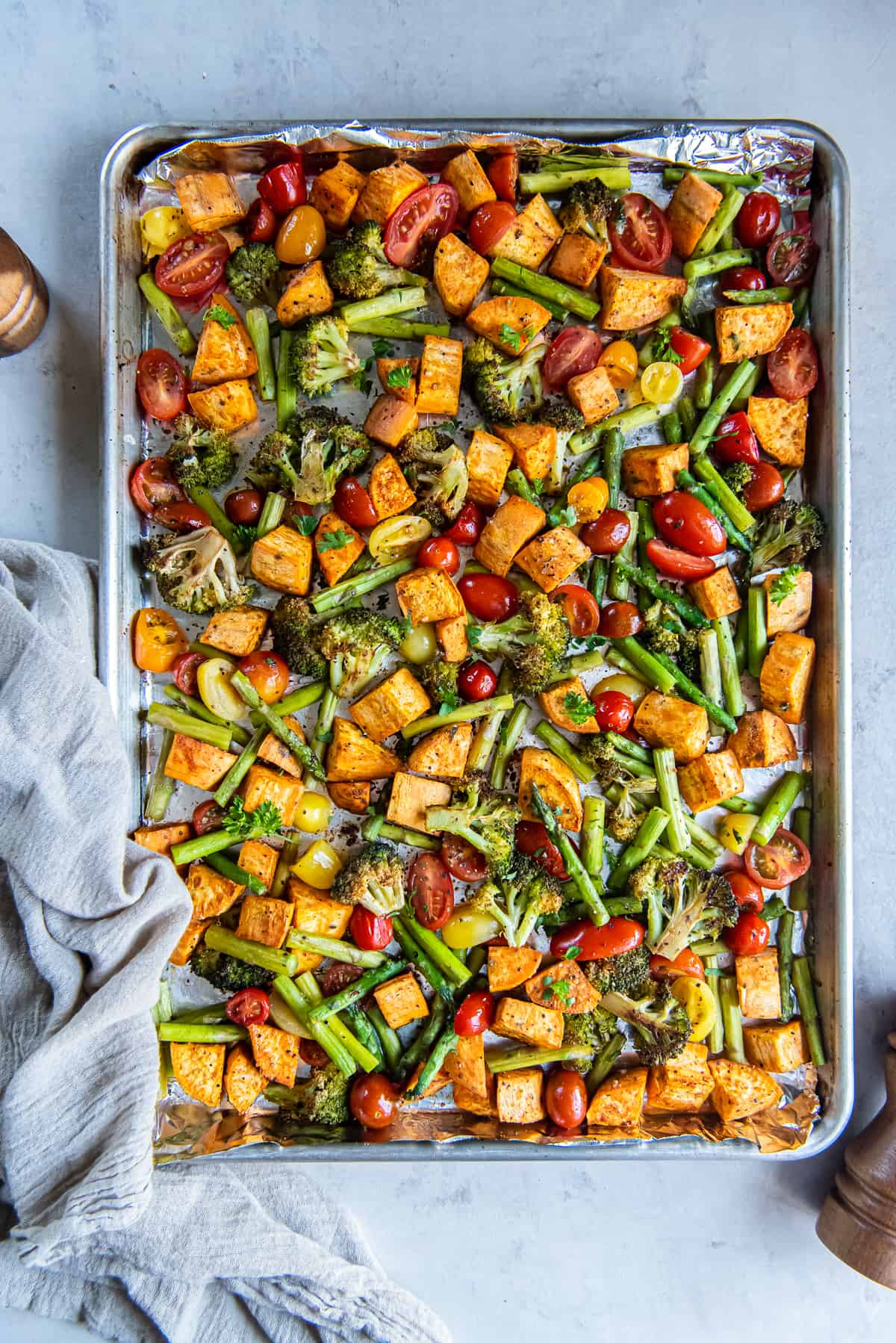 A top down shot of roasted vegetables on a sheet pan.