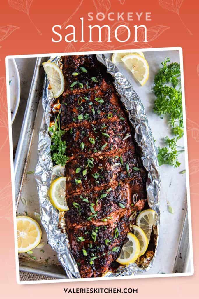 Glazed sockeye salmon on a sheet of foil with lemon slices with text overlay.