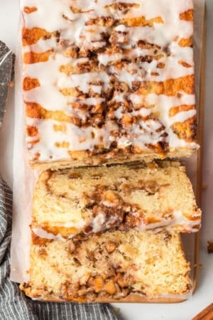 A top down close up shot of sliced apple fritter bread on a board.