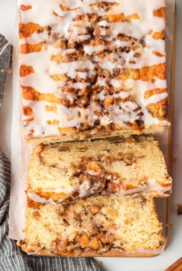 A top down close up shot of sliced apple fritter bread on a board.