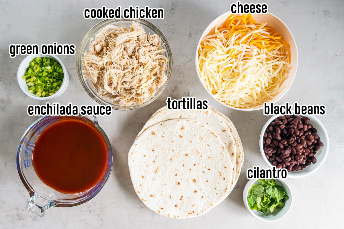 Cooked chicken, shredded cheese, enchilada sauce and other ingredients in bowls with text.