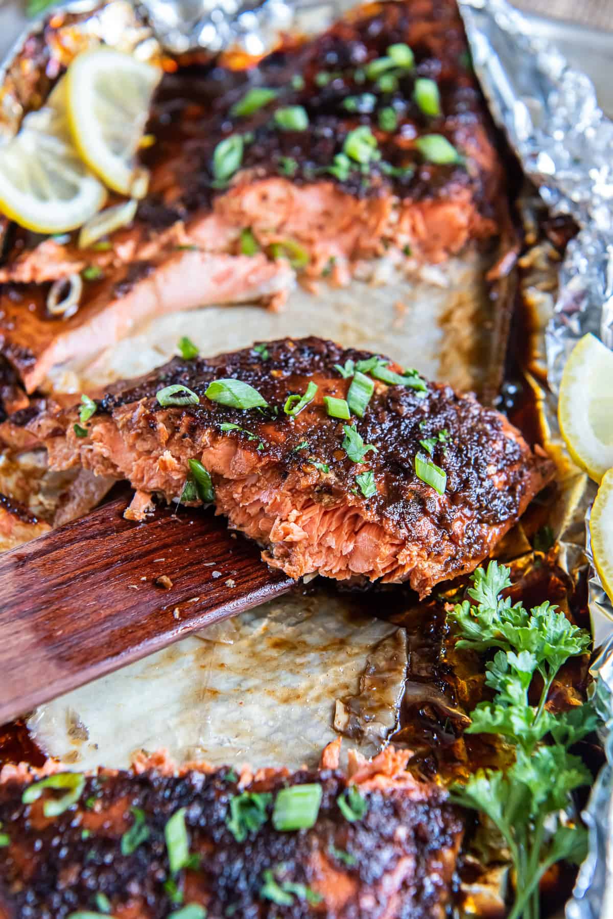 A spatula lifting a slice of salmon.