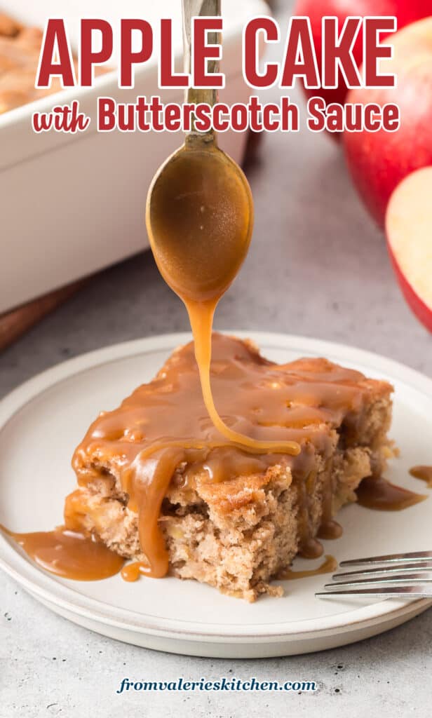 Butterscotch sauce drizzling off the end of a spoon and on to a slice of apple cake on a plate.
