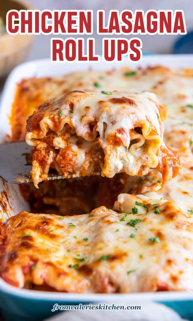 A spatula lifting a cheesy chicken lasagna rollup from a baking dish with text.