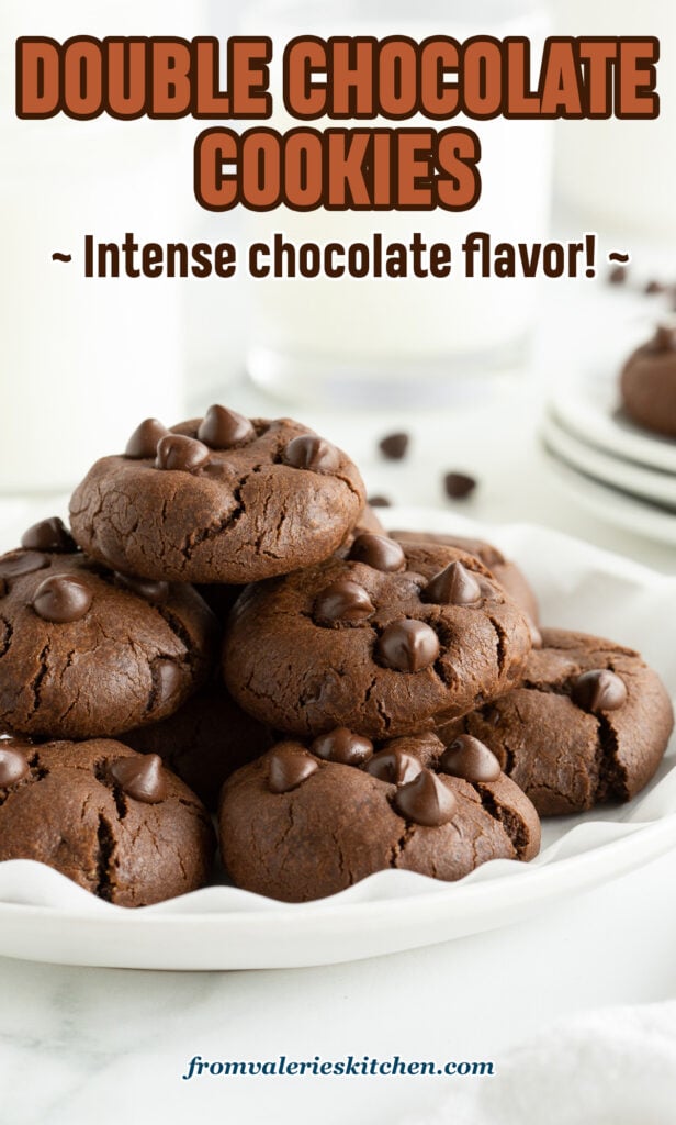 A stack of chocolate cookies with chocolate chips on a white plate with text.