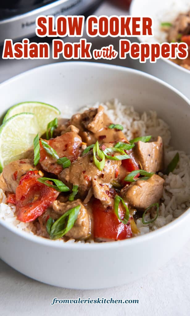 A serving of Asian pork with peppers over rice with lime wedges in a small white bowl with text.