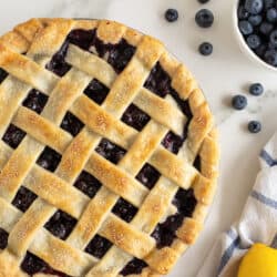 A top down shot of a blueberry pie with a lattice crust.
