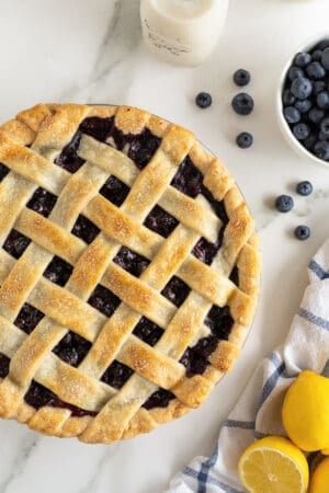 A top down shot of a blueberry pie with a lattice crust.