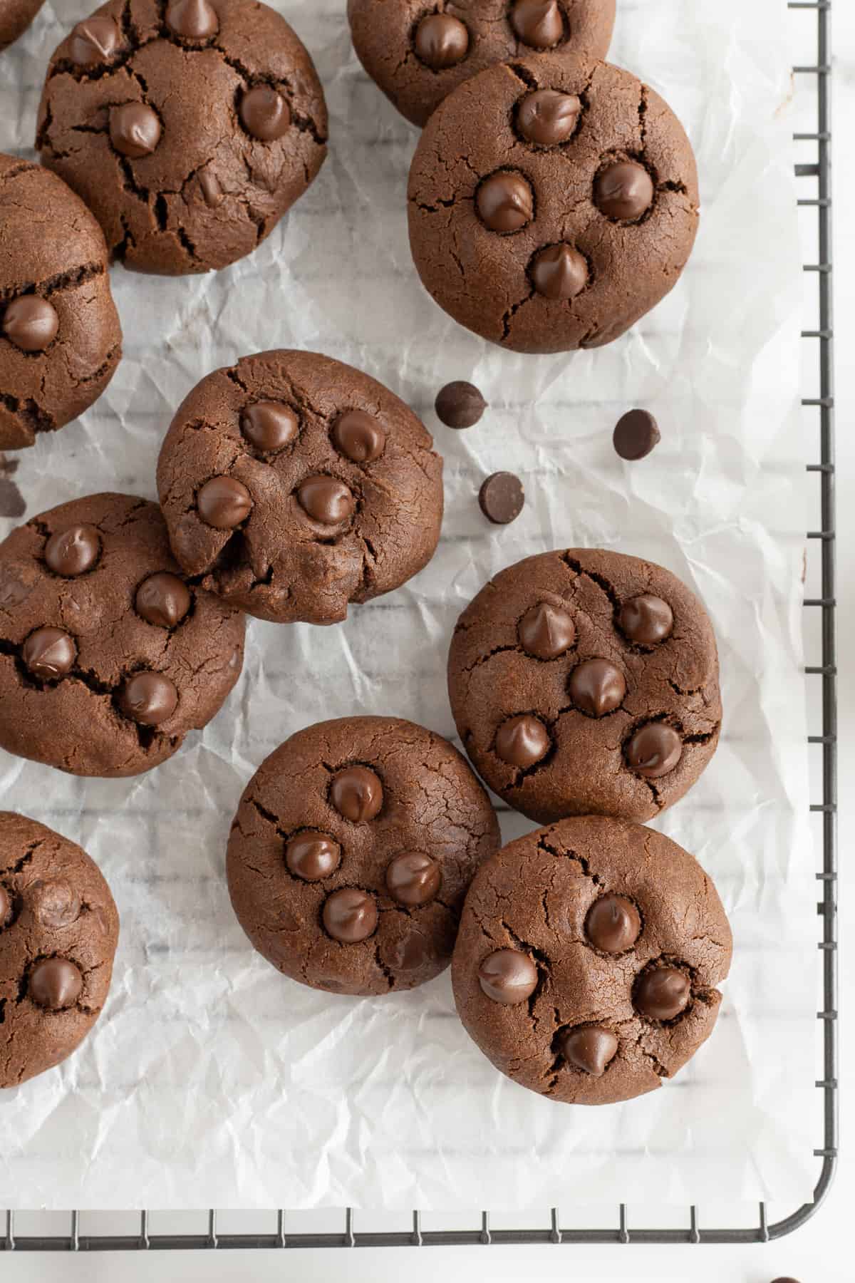 A top down shot of double chocolate cookies on a wire rack.