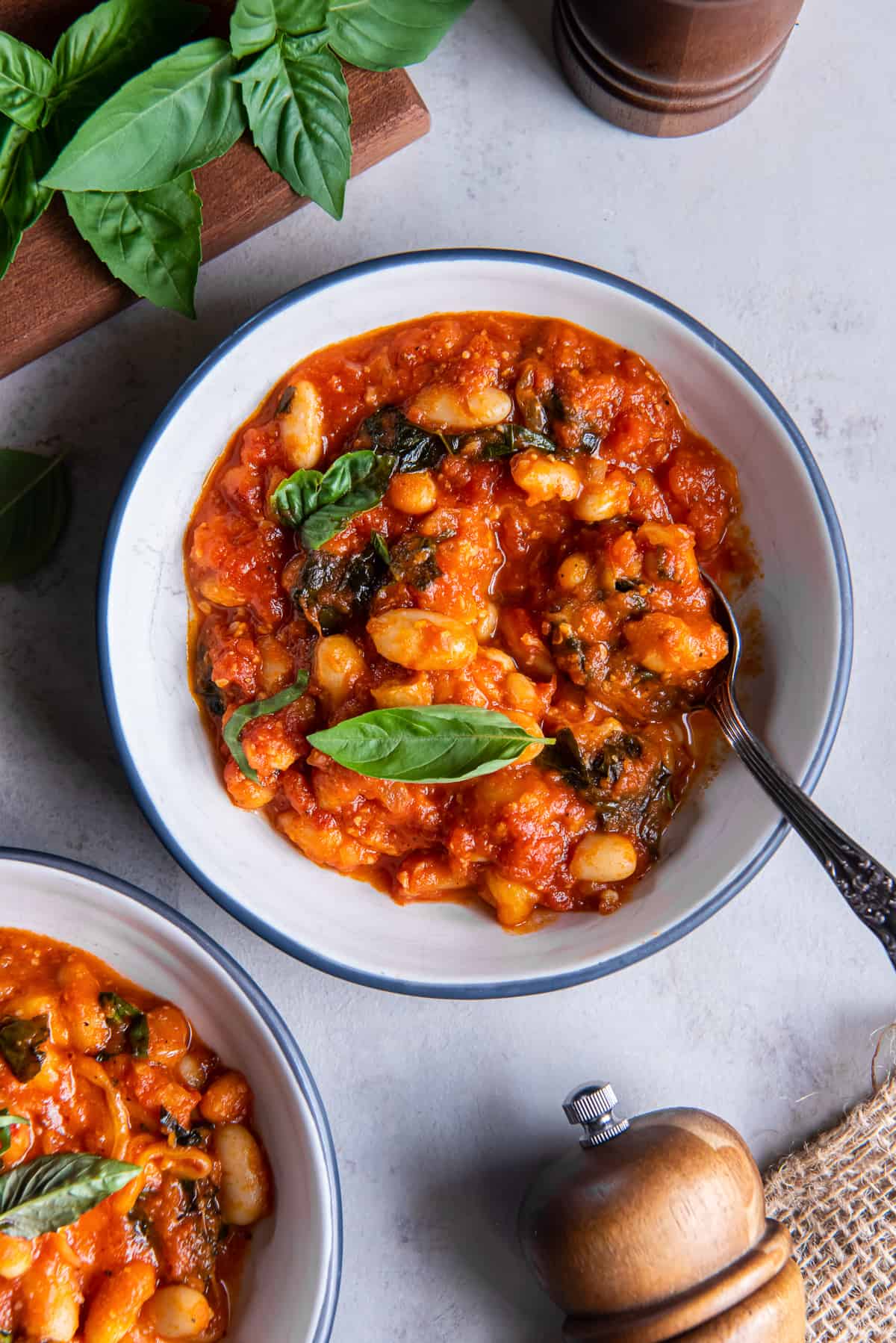 A top down shot of two small bowls filled with Italian Beans.