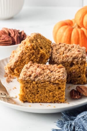Three slices of pumpkin crumb cake on a white plate.