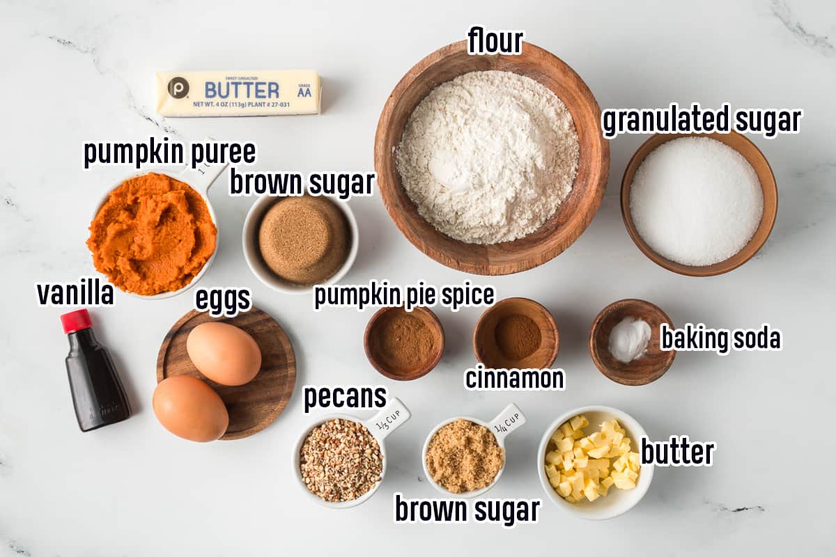 Flour, sugar, pumpkin puree, spices and other ingredients in bowls with text.