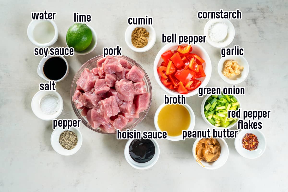 Chunks of pork, red bell peppers, a lime and other ingredients in bowls with text.