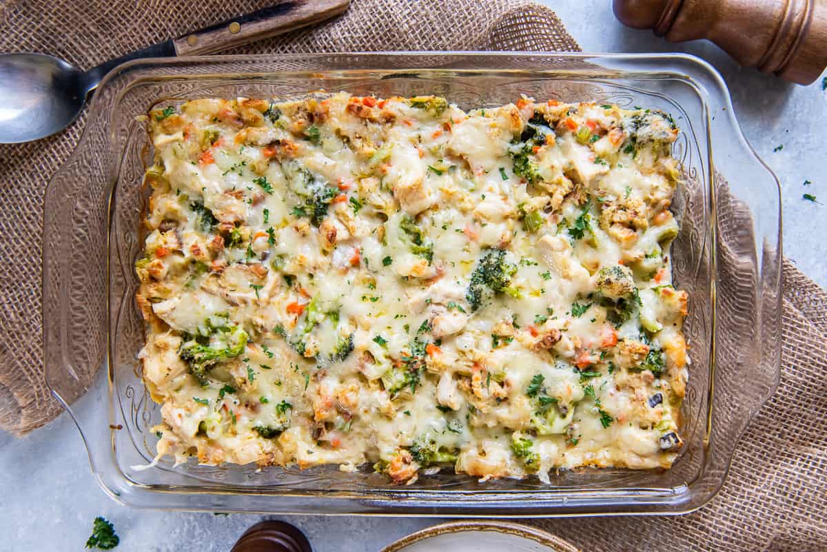 A top down shot of chicken stuffing bake with broccoli and swiss cheese in a baking dish.